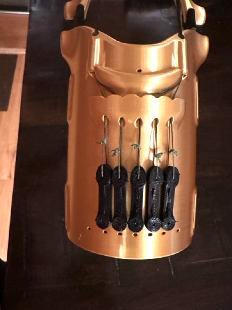 Inside the forearm, tensioner pulleys and cord routing