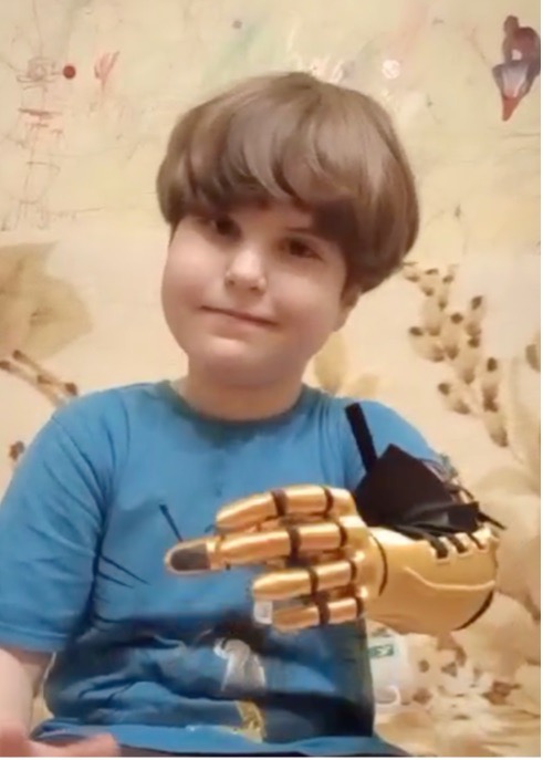 A. smiling proudly with the arm on, January 2025