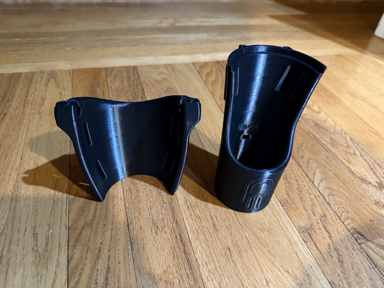 Two forearm pieces side by side on wood floor showing the split and epoxy join solution