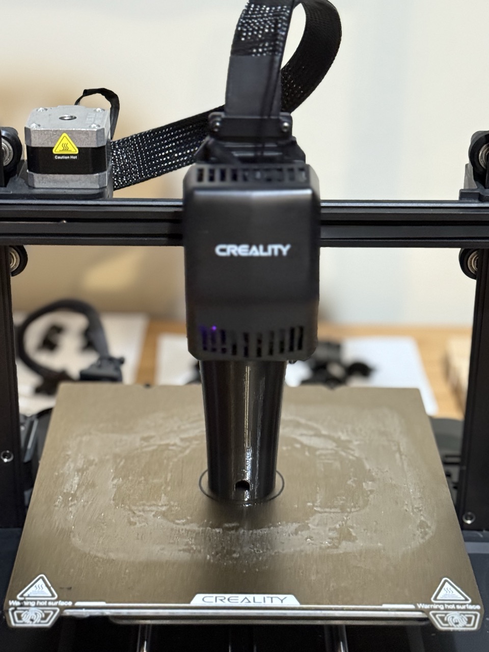 Wrist cup piece mid-print on Creality printer, purple LEDs glowing