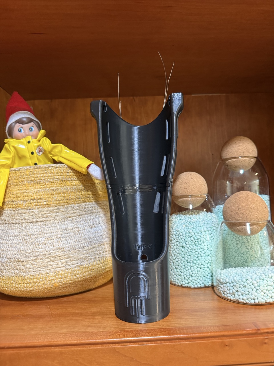 E.F.'s two-piece forearm shell standing on a shelf, epoxy join visible at center