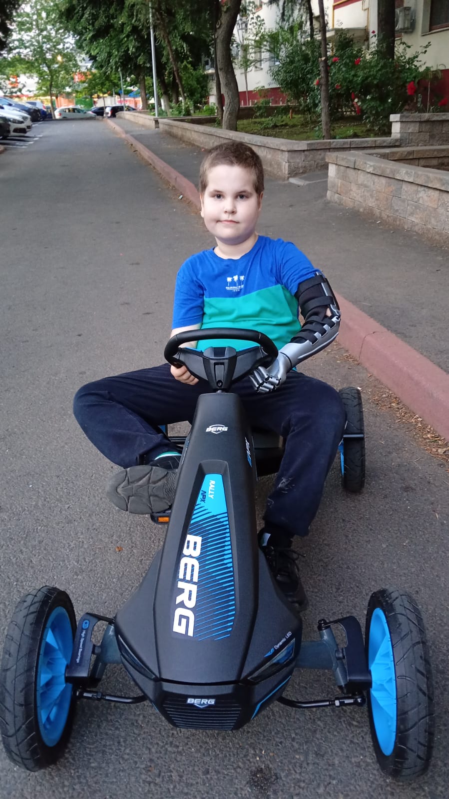 A. from Bucharest, Romania, sitting in his go-kart with his silver Kinetic Arm